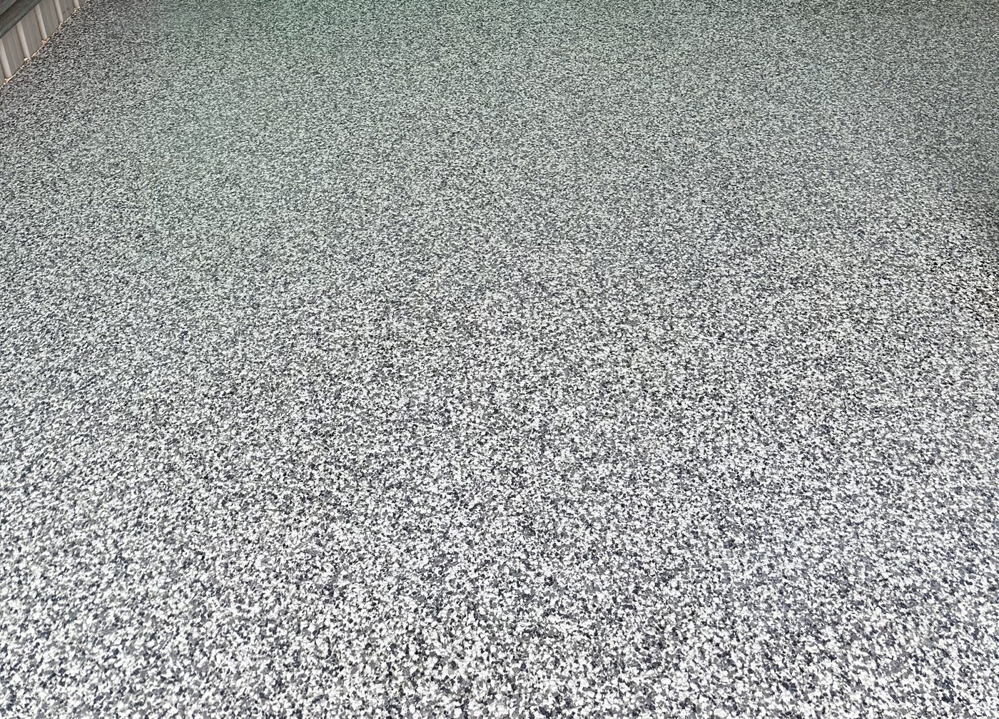 Grey flake epoxy floor in a carport by Hobart Epoxy Floors